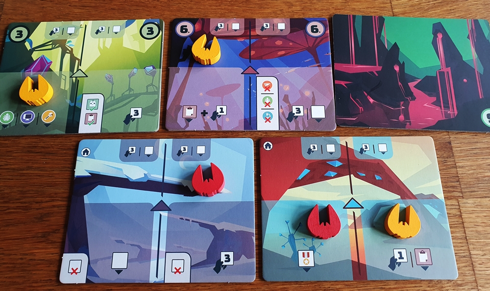 Fünf ausliegende Planetenkarten, Spielsteine Raumschiffe darauf