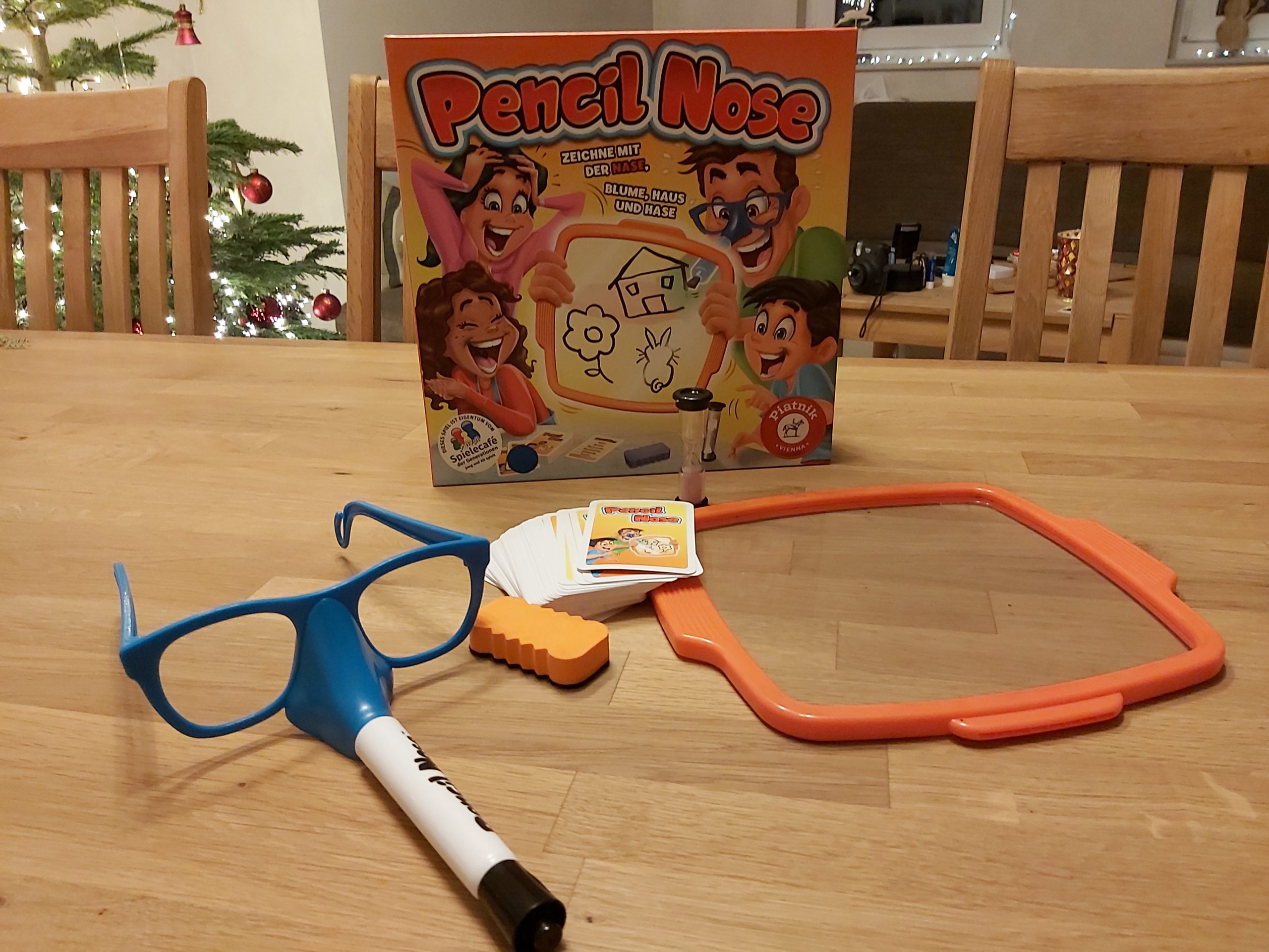 Zu sehen ist das Spiel Pencil Nose! mit allen Spielmaterialien.