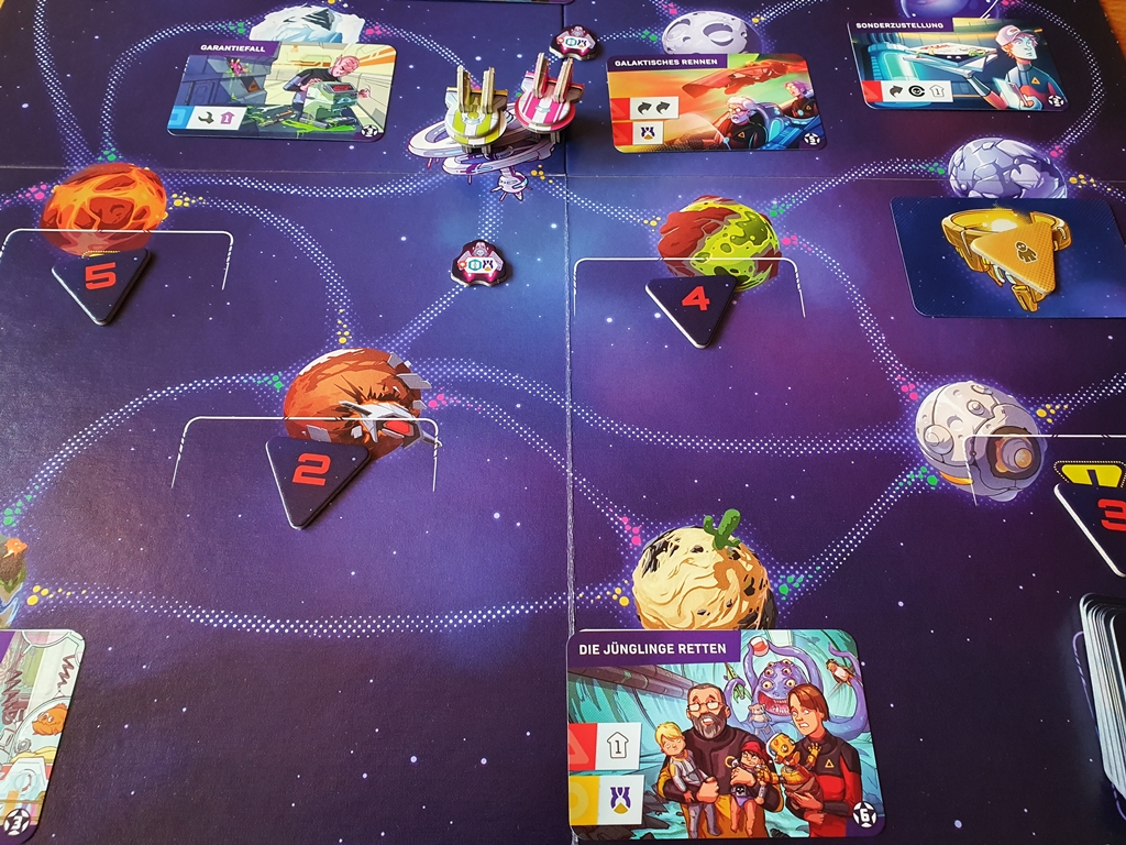Teil des Spielbretts, darauf Missionskarten und zwei Raumschiffe