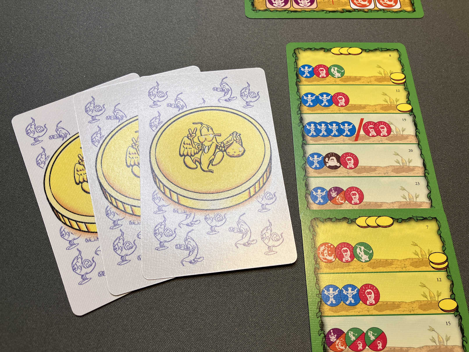 Umgedrehte Auftragskarten zeigen Münzen für die Wertung