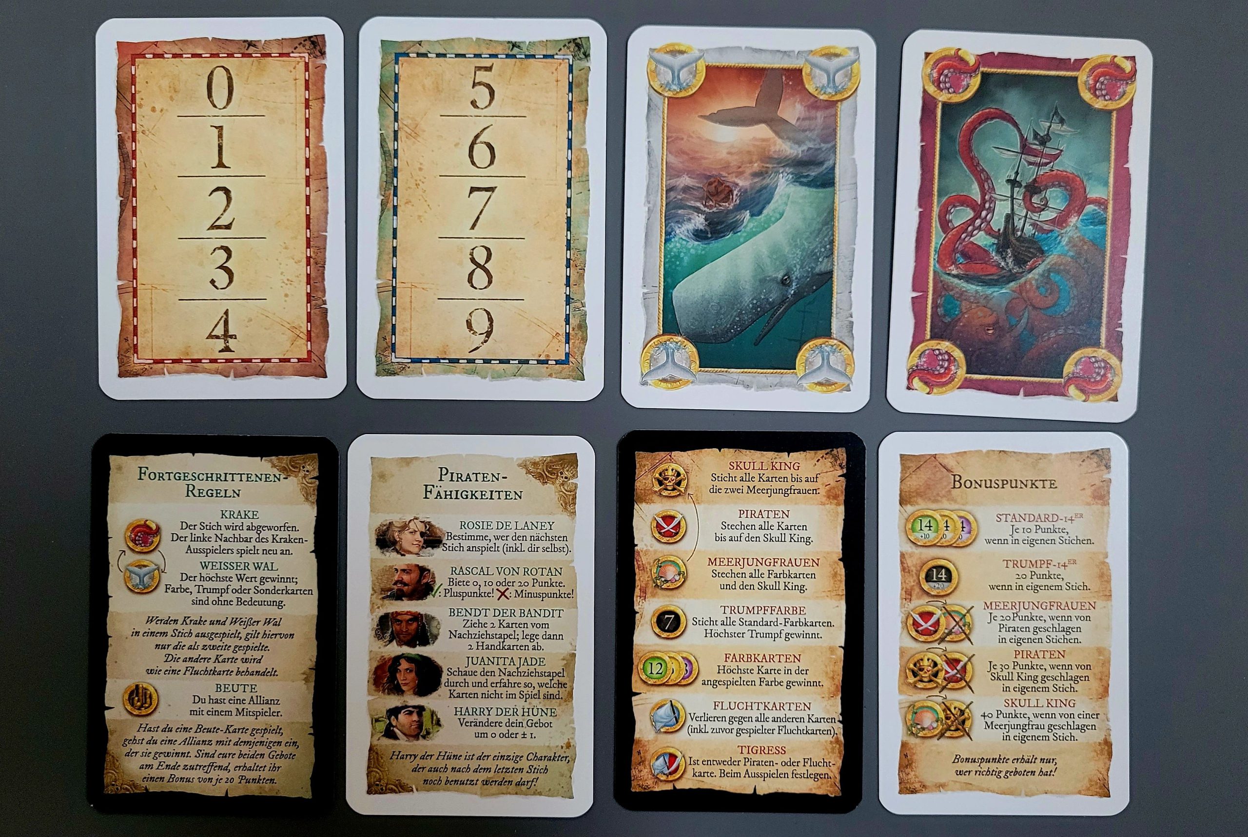 Gezeigt werden Gebotskarten und Spielhilfen.