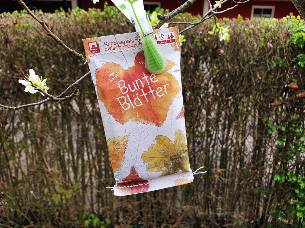 Spieltüte, mittels Wäscheklammer im Baum hängend