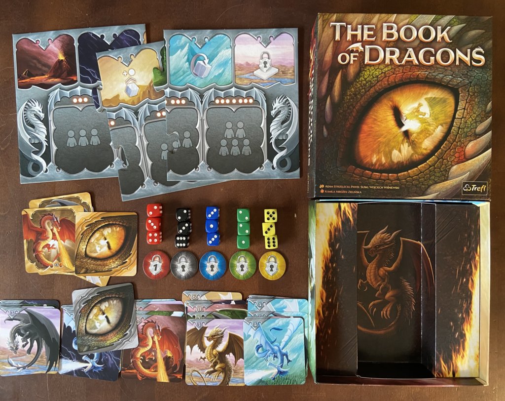 Material und Schachtel des Spiels The Book of Dragons.