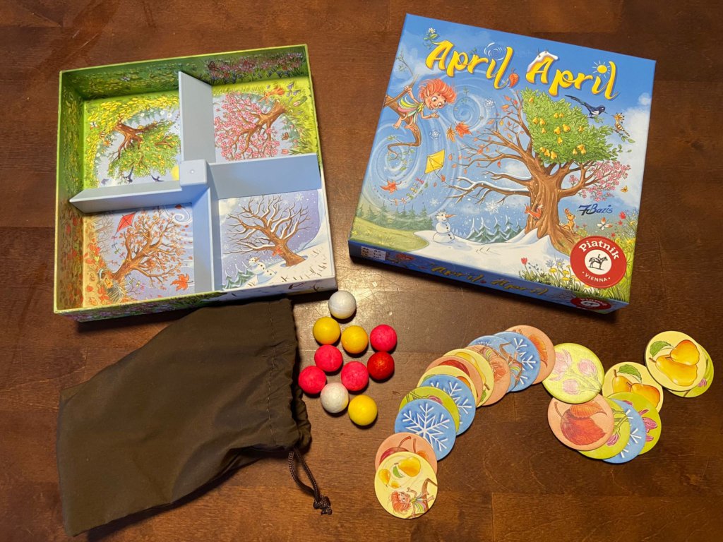 Schachtel mit Einsatz, Styroporbälle und runde Pappplättchen zum Spiel April, April